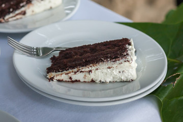 The wedding cake is cut into pieces.