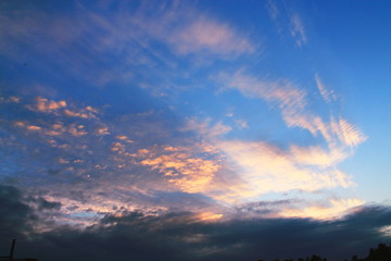 Naklejka na ściany i meble Beautiful sunset sky above clouds with dramatic light. Cabin view