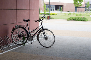 Fototapeta na wymiar Locked bicycle at bicycle parking. Transport, storage and vehicle concept