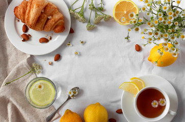 Still life with food, drinks and flowers. Objects are placed in a circle, at the edges of the picture. Copy space in the center