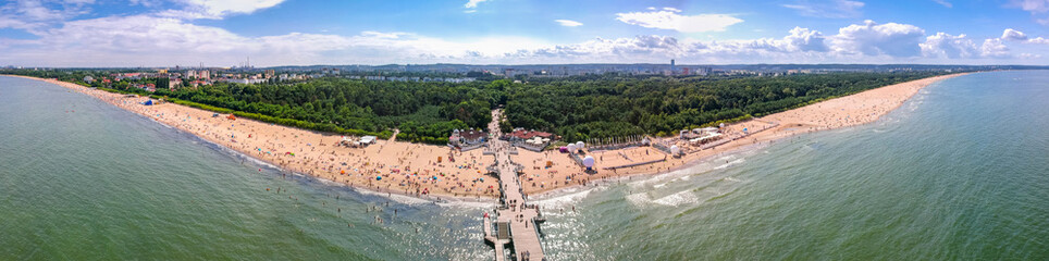 Summer beach panorama with wooden pier at Baltic Sea in Gdansk, Poland.