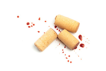 Spilled red wine and corks isolated on white background - Image