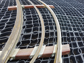 Curved rails lying on a plastic floor