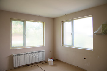 Painting walls in room with roller and ladder during renovation - Image