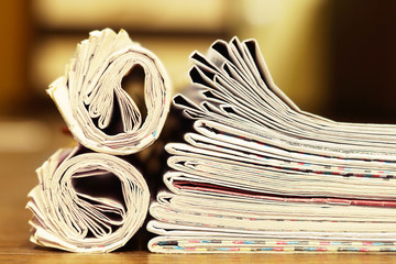 Newspapers Folded and Rolled. Stack of Magazines and Journals on the Table. Close up View of Business Papers with News, Pages with Headlines and Articles 