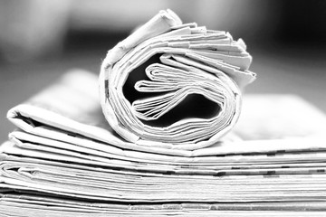 Newspapers Folded and Rolled. Stack of Magazines and Journals on the Table. Close up View of Business Papers with News, Pages with Headlines and Articles 