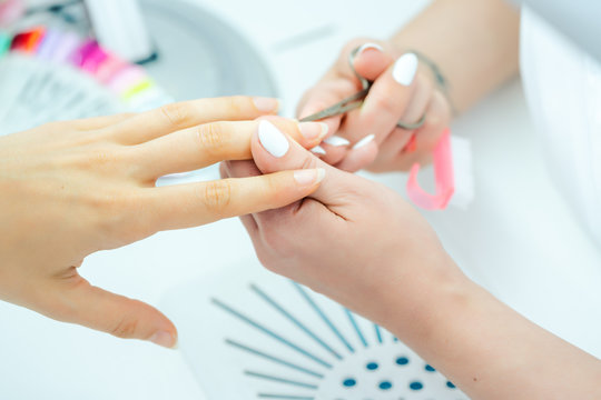 Woman having her finger nails cut during manicure
