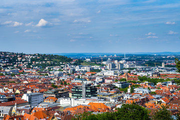 Fototapeta na wymiar Germany, Wide view aerial above the red roofs of stuttgart city and feuersee church in basin surrounded by hills in summer