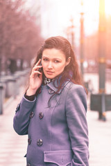 Beautiful girl talking on the phone on the street