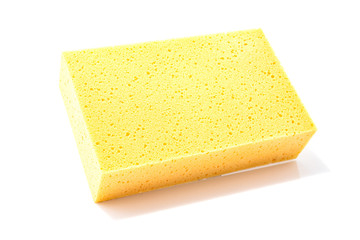 Yellow sponge for cleaning and washing car isolated on a white background. Selective focus.