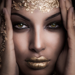 closeup of beautiful black girl with golden makeup