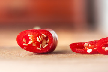 Sliced hot pepper on a wooden board.