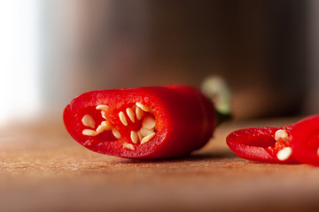 Sliced hot pepper on a wooden board.