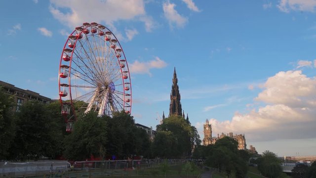 View of Princes street in Edinburgh new town with the ferris wheel and Walter Scott monument