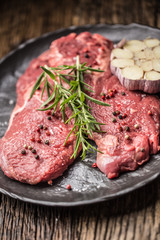 Beef meeat Rib-Eye steak wit rosemary salt and pepper on black plate