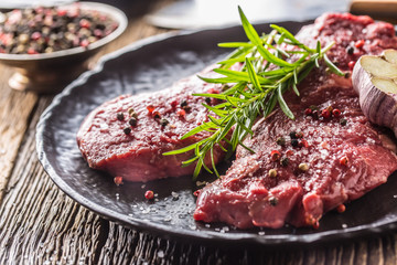 Beef meeat Rib-Eye steak wit rosemary salt and pepper on black plate