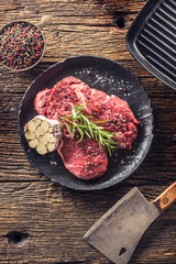 Beef meeat Rib-Eye steak wit rosemary salt and pepper on black plate