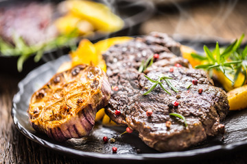 Grilled beef Rib Eye steak with garlic american potatoes rosemary salt and spices