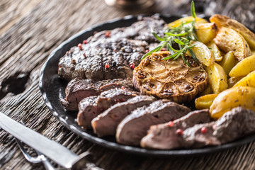 Grilled beef Rib Eye steak with garlic american potatoes rosemary salt and spices