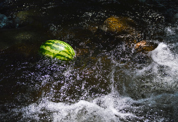 Watermelon in a river water stream