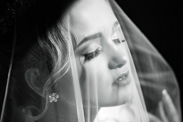 Beautiful bride in veil, fashion bride. Beautiful sexy bride posing under veil. Bride portrait wedding makeup and hairstyle with diamond crown.  Black and white.