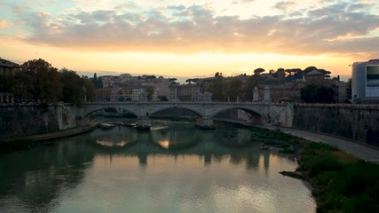 Sunset view of St. Peters Basilica in the Vatican and the Ponte Sant'Angelo Bridge of Angels at the Castel Sant'Angelo and river Tiber in Rome Italy