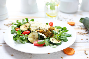 Casserole. Zucchini stuffed with green lentils and vegetables. A healthy vegetarian diet