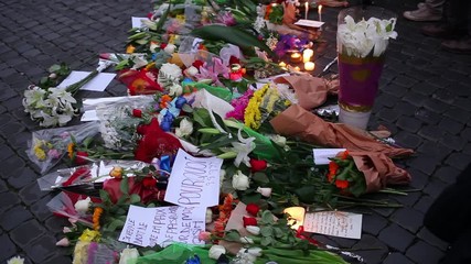 Flowers and lit candles in front of the French Embassy in Piazza Farnese in Rome after the terrorist attacks in Paris on 13 November.