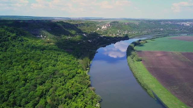 Flight over the river and forest at spring time. Dniester river of Moldova republic.