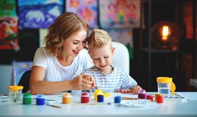 mother and child son  painting draws in creativity in kindergarten.mother and child son  painting draws are engaged in creativity in kindergarten.