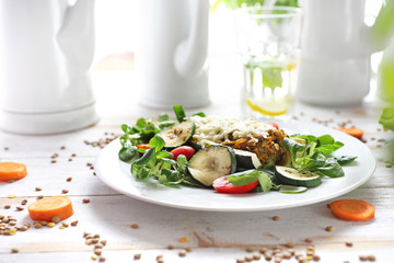 Casserole. Zucchini stuffed with green lentils and vegetables. A healthy vegetarian diet
