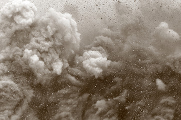 Rock particle and dust clouds after detonator blast