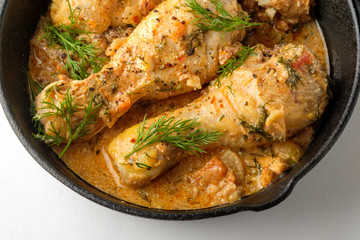 Spicy chicken in a sauce in a frying pan. top view from above