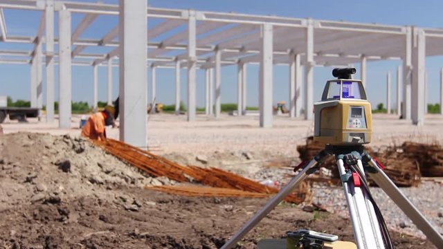 Total center device on tripod with laser for leveling other devices to level construction site. H.264 video codec