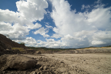 Fototapeta na wymiar Open coal mining pit with heavy machinery