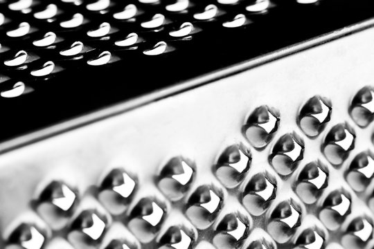 Macro close up image of a stainless steal cheese grater view from the side