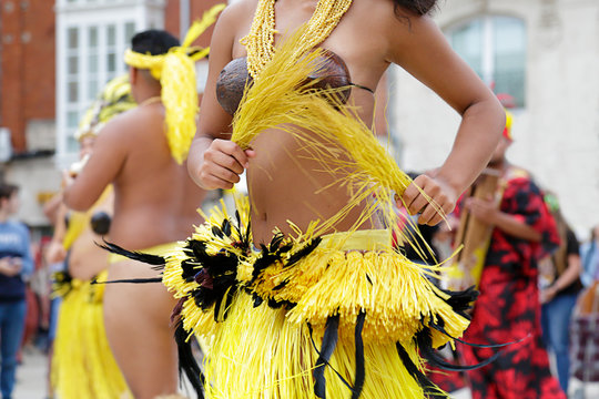 Woman dancing and wearing the traditional folk costume from Tahiti, French Polynesia.