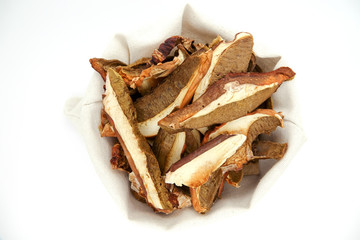 Dried white mushrooms on a white background. Dried porcini mushrooms. Isolated on white background.