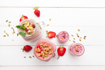 Naklejka na ściany i meble Strawberry with yogurt on white rustic wooden background. Cream dessert