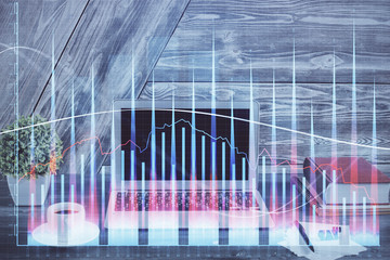 Double exposure of graph and financial info and work space with computer background. Concept of...
