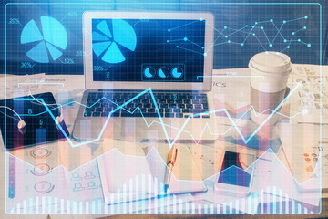 Double exposure of graph and financial info and work space with computer background. Concept of...