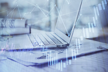 Stock market graph and table with computer background. Double exposure. Concept of financial analysis.