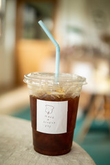 cold americano coffee on minimal table and slogan have a nice day quotes. 