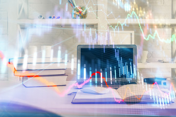 Stock market graph and table with computer background. Double exposure. Concept of financial analysis.