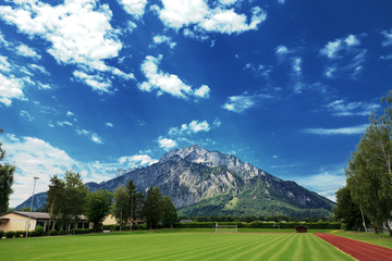 Summer landscape on sports fields and alps mountains, Austria