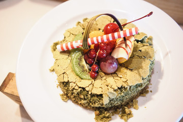 Beautiful Matcha Green tea decorated cake with mix fruits