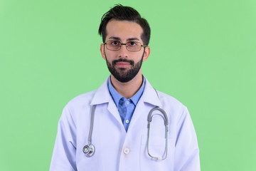 Face of young bearded Persian man doctor