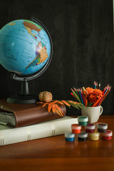 School supplies on blackboard background ready for your design