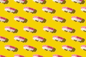 Photography collage of gummy milk teeth or jelly candies on bold yellow background top view flat...