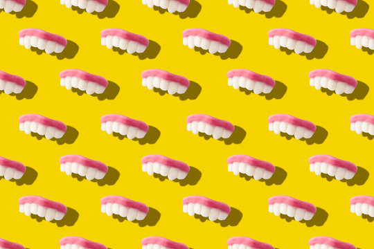 Photography collage of gummy milk teeth or jelly candies on bold yellow background top view flat lay isometric seamless pattern.Funny children's treats.Halloween holiday concept.surrealism,pop-art  - Powered by Adobe